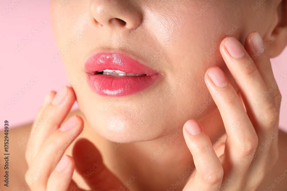 Fototapeta premium Woman with beautiful lipstick on her lips against pink background, macro view