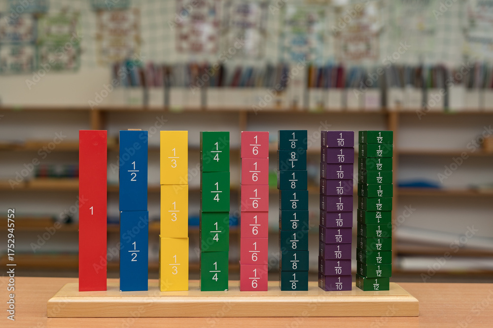 Naklejka premium Practical wooden material Fraction Tower according to the Montessori method for alternative learning of mathematics, namely the concept of fractions in preschool and primary schools.