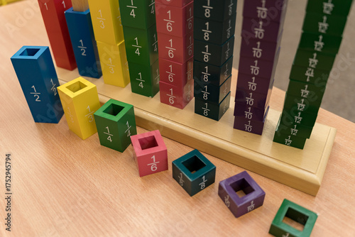 Practical wooden material Fraction Tower according to the Montessori method for alternative learning of mathematics, namely the concept of fractions in preschool and primary schools.