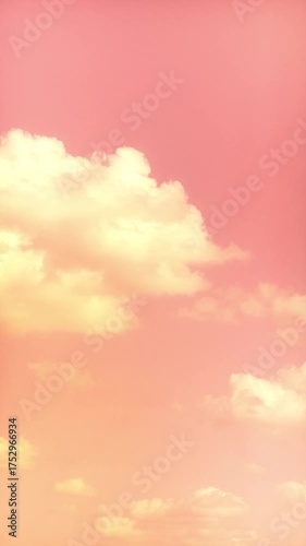 Cloudy sky at sunrise. Light pink light from the setting sun. Romantic background with clouds.