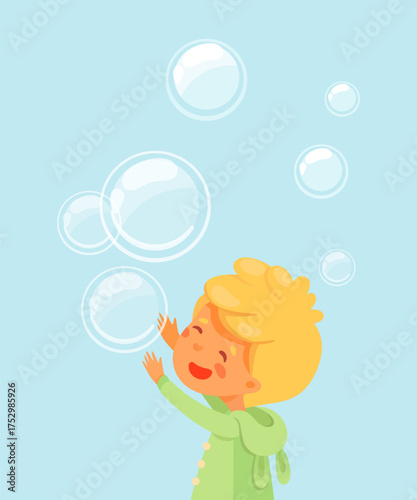 Boy playing with soap bubbles. Happy blonde kid in green coat reaching up on blue background with floating translucent spheres. Joyful childhood moment in soft cartoon vector illustration.