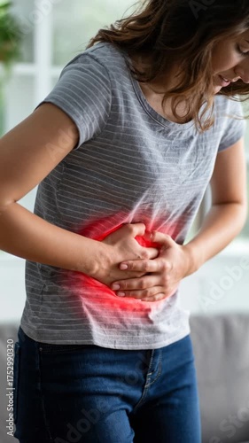 Woman suffering from severe abdominal pain with hands on stomach showing red highlighted area indicating discomfort.