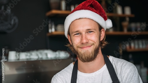Cheerful barista in Santa hat, wearing apron, in a cafe with blurred shelves and cups, close - up, copy space.