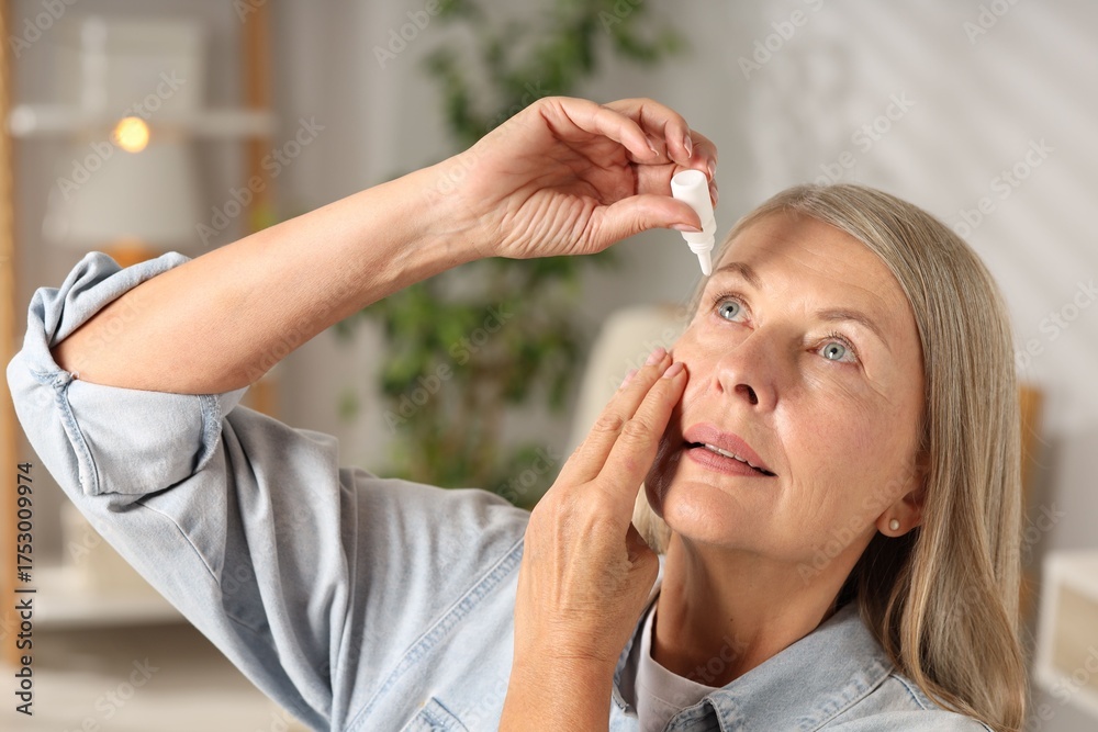 Fototapeta premium Senior woman applying eye drops at home