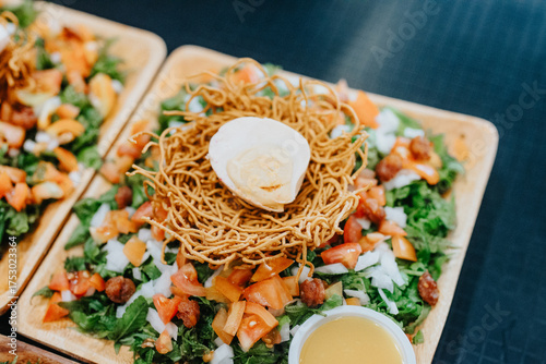 Crispy Pancit Lucban Noodle Nest with Soft-Boiled Egg on Colorful Salad in Lucban, Quezon Province, Philippines