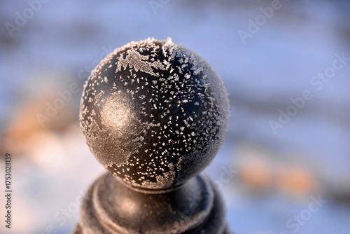 Ice crystals and snowflakes on a metal ball