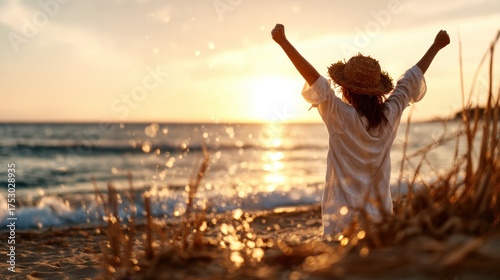 A woman raises her arms in joy against a stunning sunset on the beach, celebrating the beauty of nature and the liberation of spirit, embracing life and freedom.