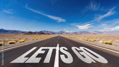Long straight road in desert with Let's Go text