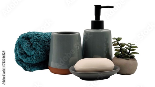 Photo of a bathroom accessory set featuring a teal towel, ceramic soap dispenser, soap dish, toothbrush holder, white bar soap, and a mini potted plant, ideal decor for a modern home or Spa.