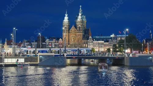 Amsterdam, Netherlands - 20.08.2025: Night view of Amsterdam cityscape with canal, bridge and medieval houses