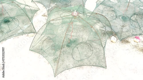 Wallpaper Mural Close-up View of Green Fishing Nets Set on White Sandy Beach with Soft Natural Light Highlighting the Intricate Design Details and Textures Torontodigital.ca