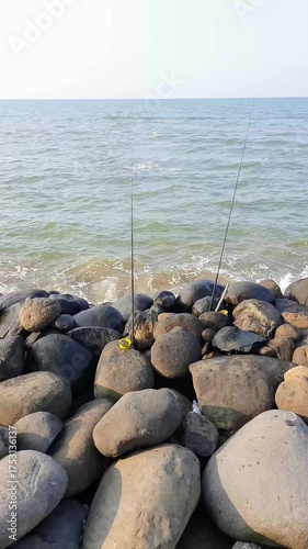 Fishing rod stays on the beach rocks