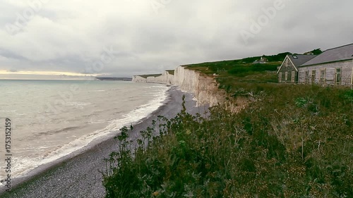 Cinematic view from a hilltop overlooking sea waves gently crashing on rocky cliffs. Peaceful travel scene with soft wind and natural sound. Perfect for relaxation, nature, and travel projects.