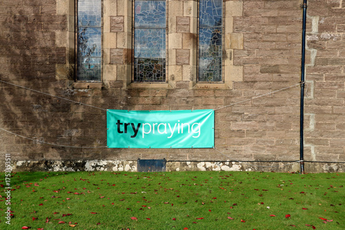 Try Praying Banner Hanging at an Urban Church Wall
