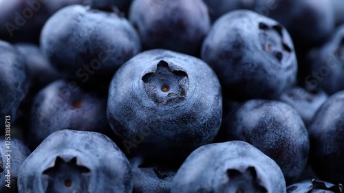 Close up of fresh blueberries piled high healthy fruit background.