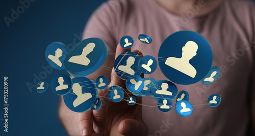 Concept of teamwork and networking with a man pointing at floating blue person icons. Represents HR, social media, or network.