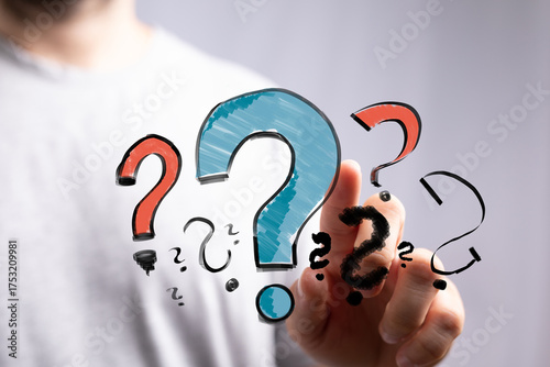 Hand pointing at question m...