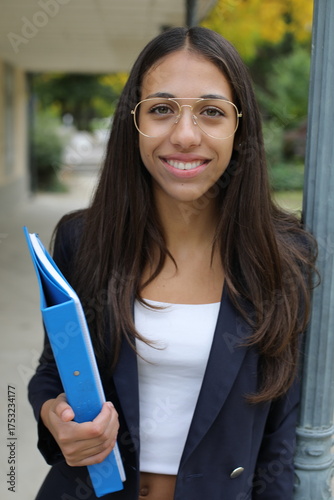 Elegant female teenage student walking around campus