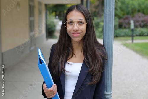 Academic Joy: Cute Young Hispanic Woman Smiling Outside College