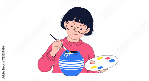 A young person enjoys painting a blue vase with a brush and palette of colors.
