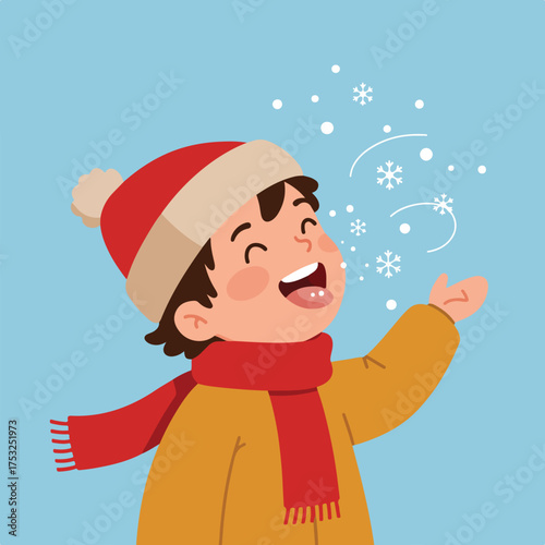 Joyful child in warm winter clothes catches snowflakes on tongue