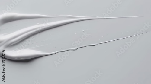 A light-gray surface with a swath of white cosmetic product