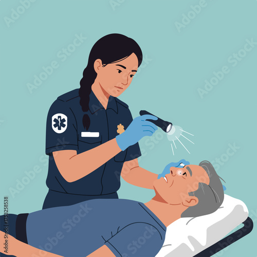 Medical professional examines patient's eye with a flashlight on a stretcher