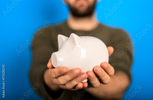A man holding a white piggy...