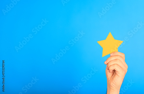 A hand holding a yellow sta...