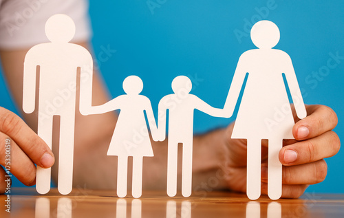 Paper family cutout held by...