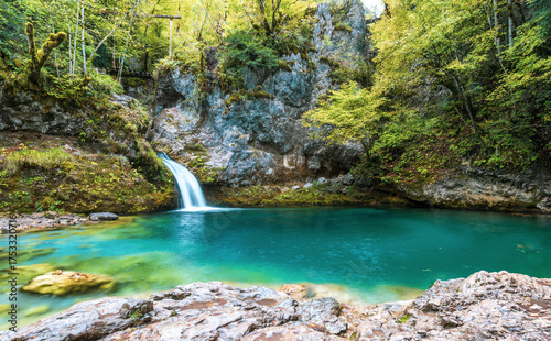 The Blue Eye of Theth, a turquoise spring and waterfall surrounded by cliffs and forest near Nderlysaj in northern Albania.