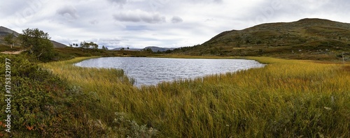 Lake Sweden autumn golden grass mountain landscape high resolution panorama.