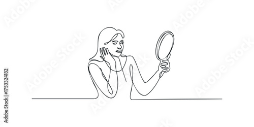 Woman examining reflection in hand mirror