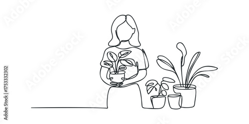 Woman holding potted plant surrounded by houseplants