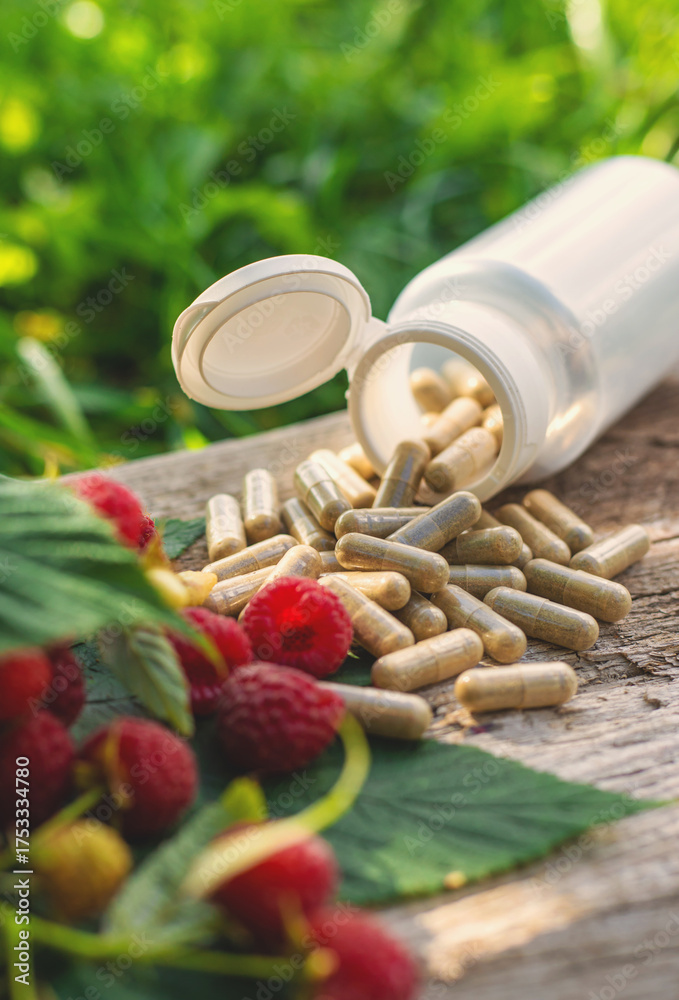 © yanadjan - Raspberry leaf extract and supplements. Selective focus.