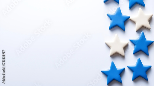 Blue and white star shapes arranged on light background create festive and cheerful atmosphere, perfect for celebrations