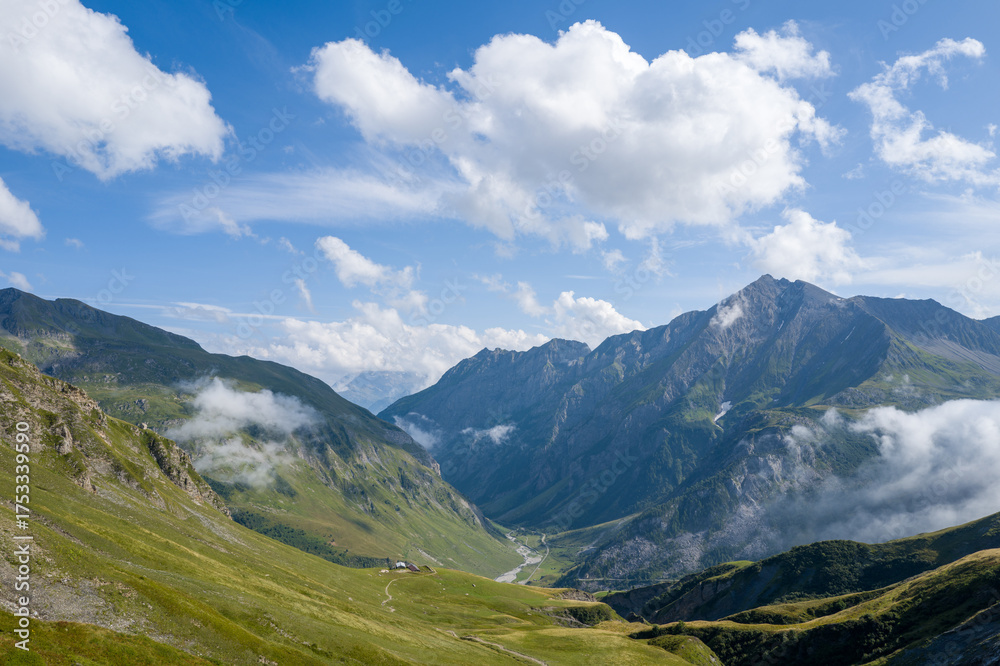 Obraz premium This landscape photo was taken in Europe, France, Auvergne Rhone Alpes, Haute Savoie, in summer. It shows the hiking path between the mountains, under the Sun.