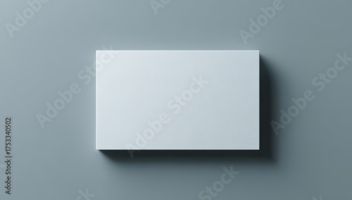 Top-down shot of a pristine rectangular card on a plain gray surface with soft shadowing