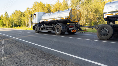 Εκτύπωση καμβά White milk tanker with drives along a highway through a forest landscape in summer