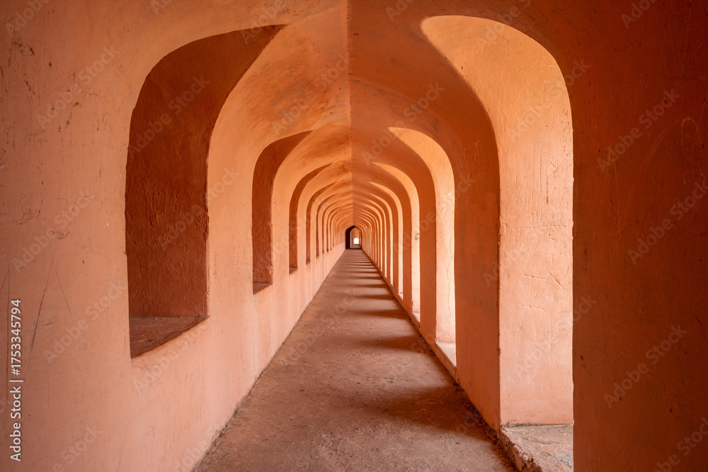 Fototapeta premium This landscape photo was taken in Asia, India, Uttar Pradesh, Lucknow, in summer. It shows the corridor of the main building of the Imambara Bara in Lucknow, under the Sun.