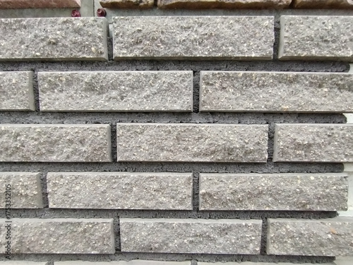 rectangular stone-like wall tiles arranged in a brick pattern