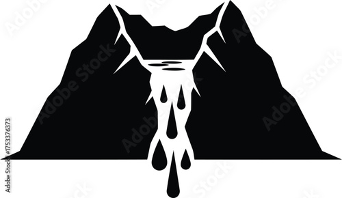 Dramatic waterfall flowing between stark mountain peaks in black and white