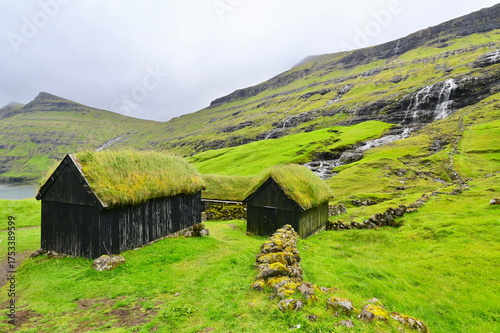 Saksun Village with Waterfall and Lush Green Mountains, One of the Most Scenic Spots in Faroe Islands
