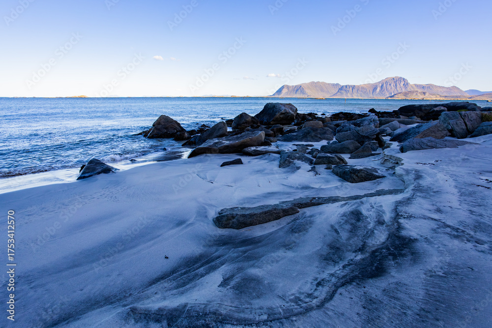 Obraz premium Autumn landscape in Lofoten Islands, Northern Norway, featuring colorful foliage, and a peaceful fjord.