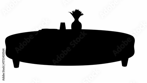 Silhouette of round ottoman with vase and glass on top, standing on four legs against a white background