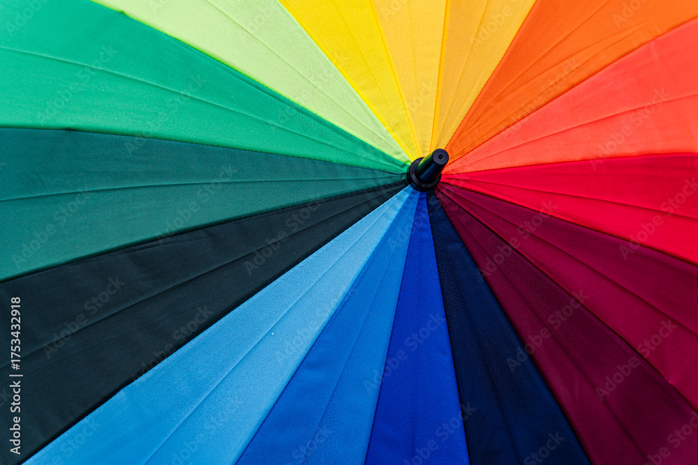© ADDICTIVE STOCK - Close-up of a vibrant rainbow umbrella