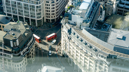 Red buses crossing busy street in London's City District