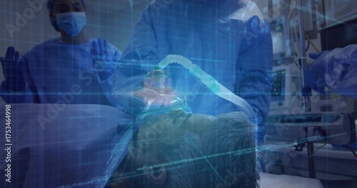 Valokuva Staff in gowns adjusting oxygen mask and tube on patient in ER, grid overlay and