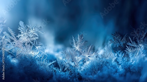 Close up view of frosted snowflakes on a winter surface with blue background