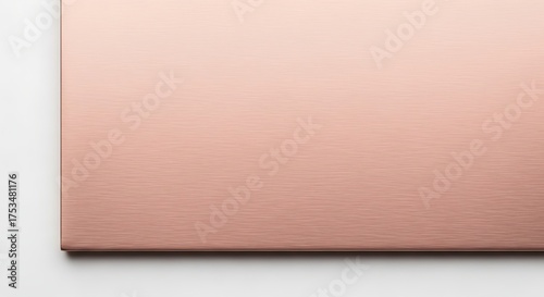 Closeup of brushed rose gold metal surface with fine texture and soft lighting, isolated on white background